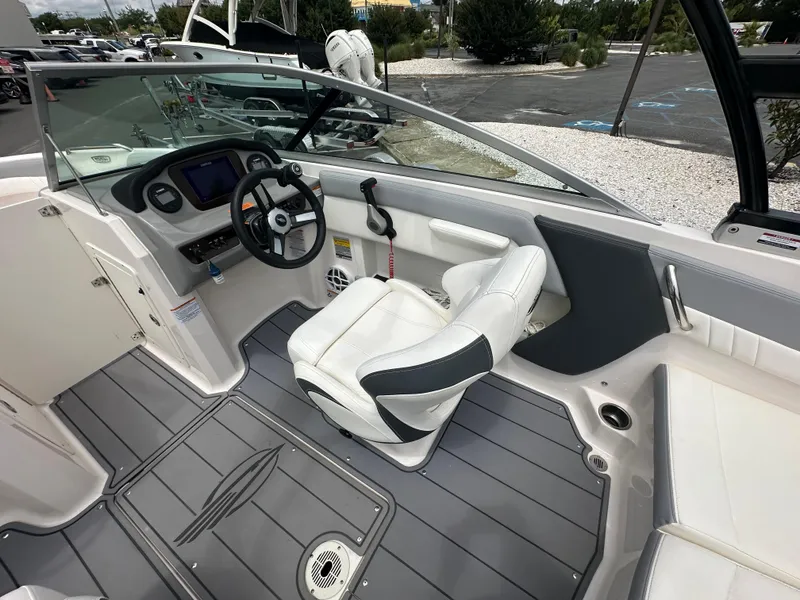 Slide: The Image of 2023 Chaparral 21 SSi OB boat interior with steering wheel and seating. - 11