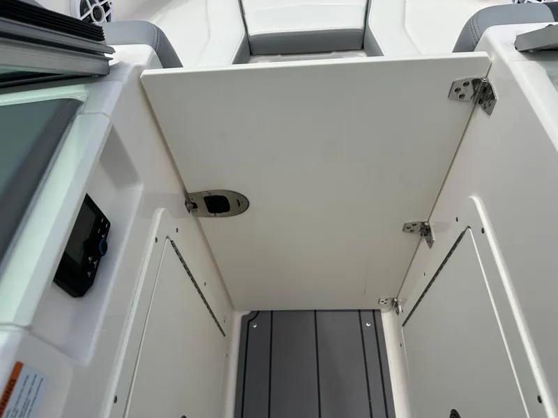 Slide: The Image of 2023 Chaparral 21 SSi OB boat interior with open storage compartment. - 13