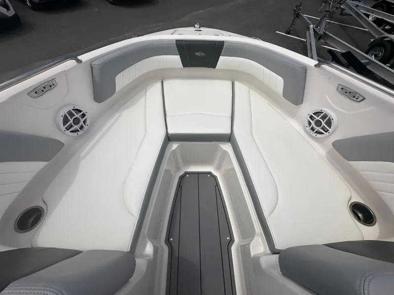 Slide: The Image of 2023 Chaparral 21 SSi OB boat interior with white and gray seating and speakers. - 16