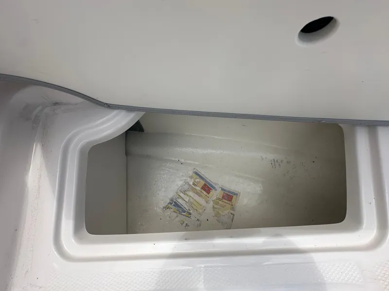 Slide: The Image of Storage compartment of 2023 Chaparral 21 SSi OB boat, showing interior details. - 17