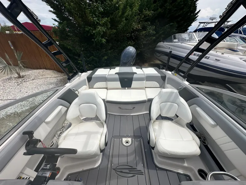 Slide: The Image of 2023 Chaparral 21 SSi OB boat interior with white seating and modern design. - 21