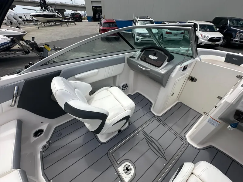 Slide: The Image of 2023 Chaparral 21 SSi OB boat interior with sleek seating and modern dashboard design. - 26