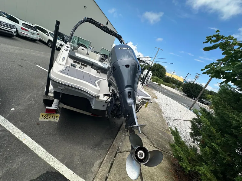Slide: The Image of 2023 Chaparral 21 SSi OB boat with outboard motor in parking lot. - 4