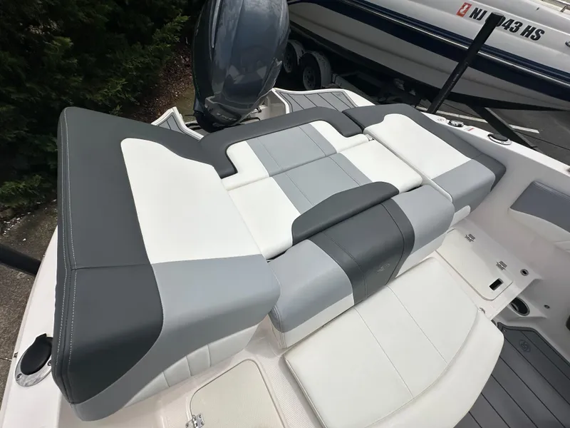 Slide: The Image of 2023 Chaparral 21 SSi OB boat interior with gray and white seating. - 7
