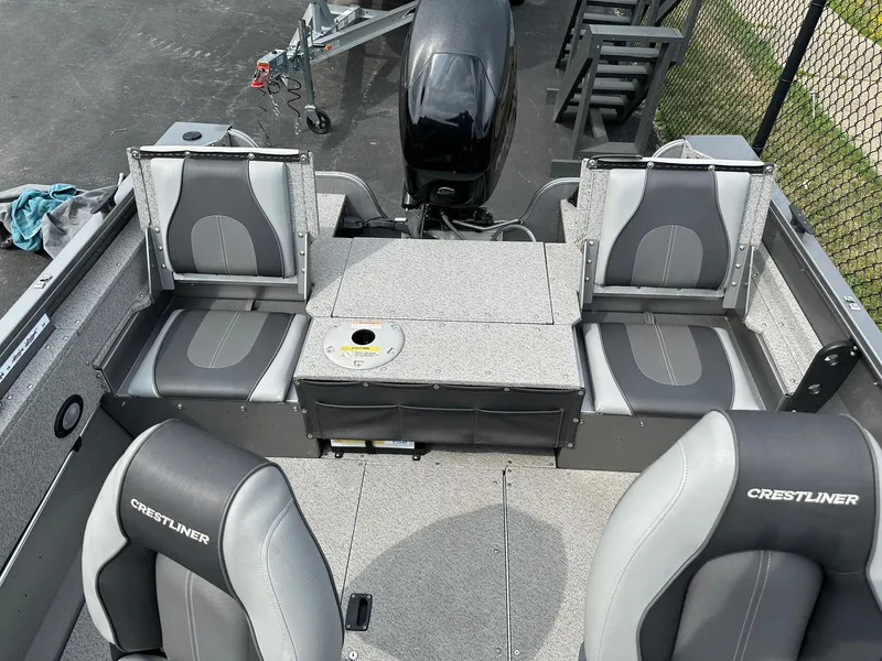 Slide: The Image of 2017 Crestliner 1600 Vision boat interior with gray seating and motor. - 3