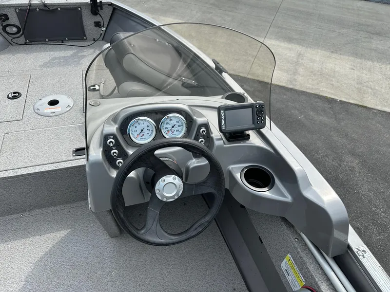 Slide: The Image of 2017 Crestliner 1600 Vision boat dashboard with steering wheel, gauges, and fish finder. - 4