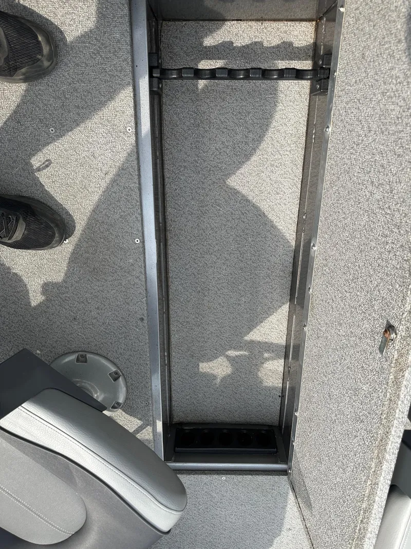 Slide: The Image of 2017 Crestliner 1600 Vision boat interior with storage compartment and seating. - 5