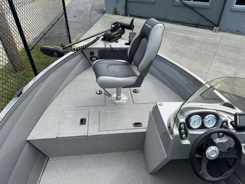 Slide: The Image of 2017 Crestliner 1600 Vision boat interior with steering console and seating. - 6