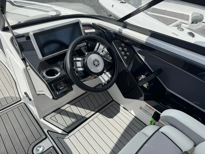 Slide: The Image of 2023 Yamaha Boats 252SD dashboard with steering wheel and touchscreen display. - 13