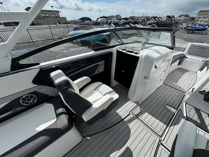 Slide: The Image of 2023 Yamaha Boats 252SD interior with sleek seating and modern dashboard design. - 17