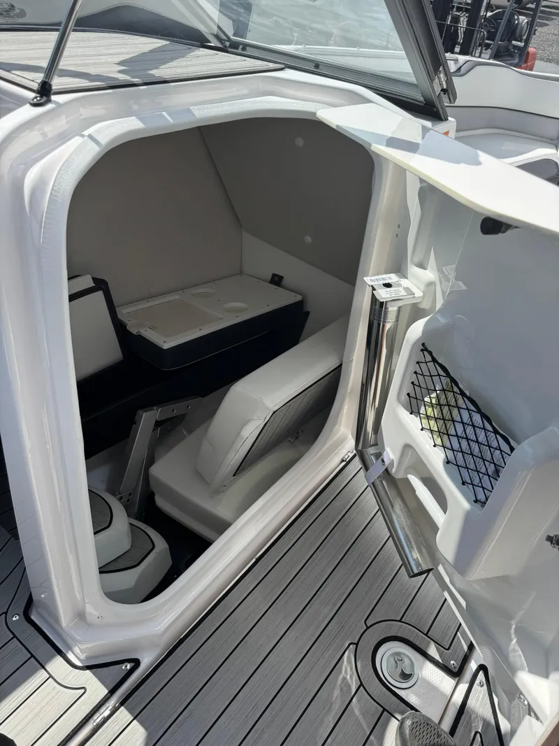Slide: The Image of 2023 Yamaha Boats 252SD interior cabin with seating and storage. - 21