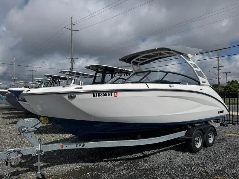 Slide: The Image of 2023 Yamaha Boats 252SD on trailer under cloudy sky. - 5