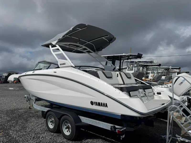 Slide: The Image of 2023 Yamaha Boats 252SD on trailer under cloudy sky. - 7