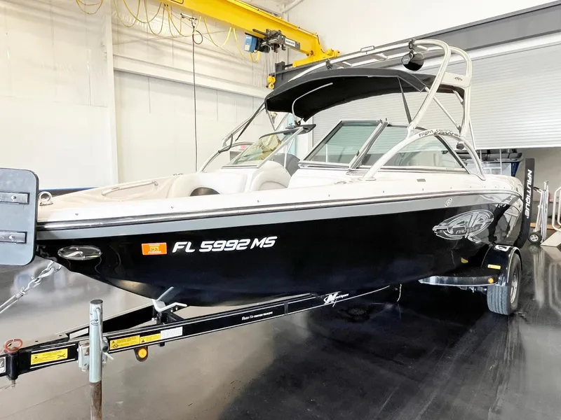 Slide: The Image of 2005 Nautique Air Nautique SV-211 boat on trailer in indoor storage facility. - 3