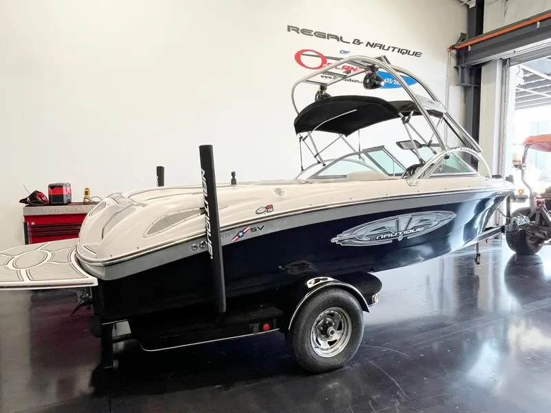 Slide: The Image of 2005 Nautique Air Nautique SV-211 boat in showroom, side view. - 4