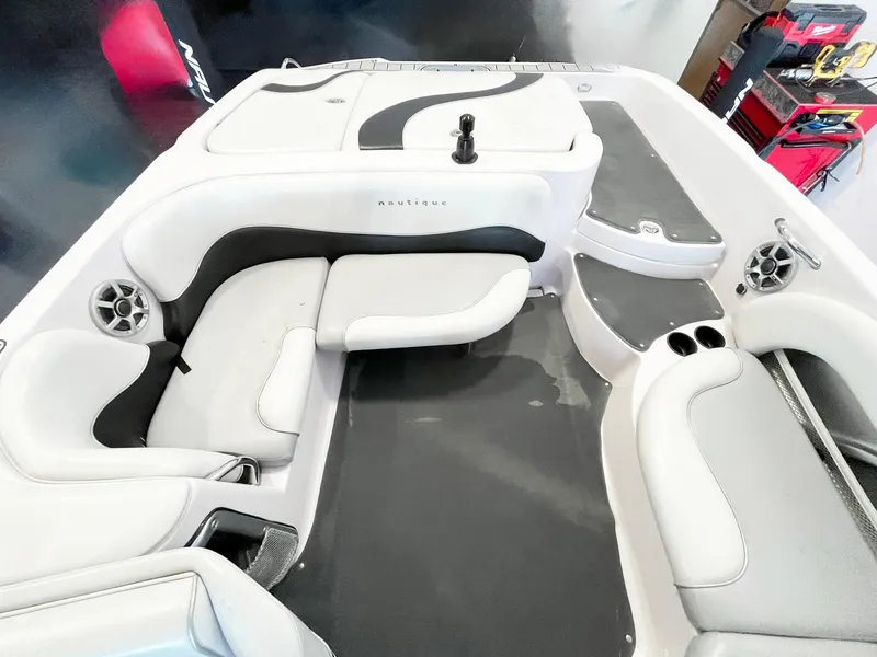 Slide: The Image of 2005 Nautique Air Nautique SV-211 boat interior with white and black seating and cup holders. - 8