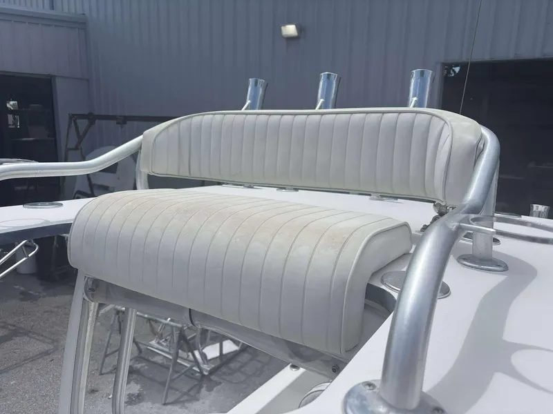 Slide: The Image of 2015 Andros Tarpon 26 boat seat with white upholstery and metal frame. - 12
