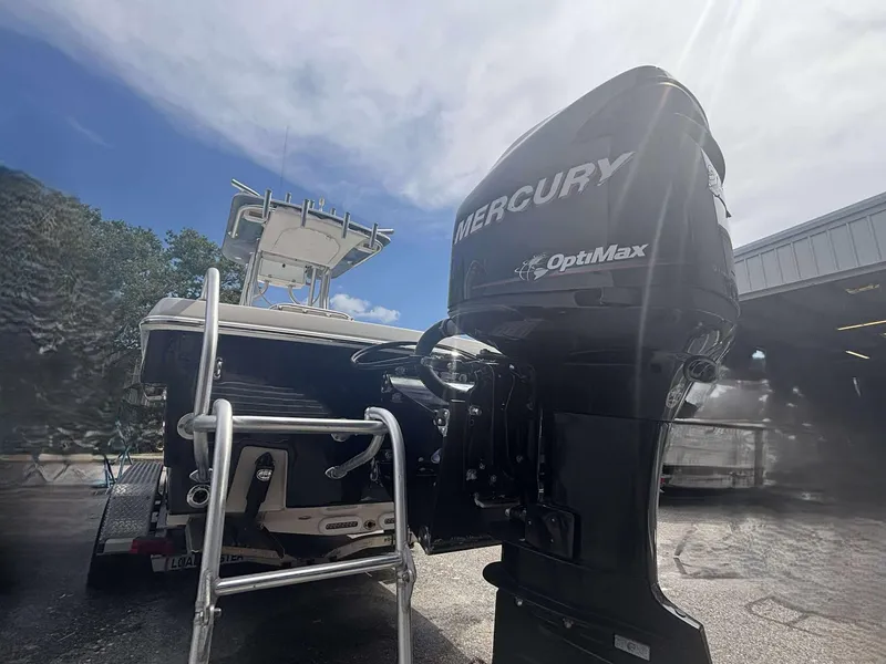 Slide: The Image of 2015 Andros Tarpon 26 boat with Mercury OptiMax engine, parked outdoors. - 14