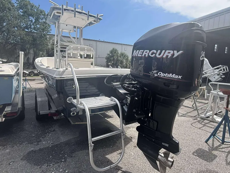 Slide: The Image of 2015 Andros Tarpon 26 boat with Mercury OptiMax engine, parked outdoors. - 15