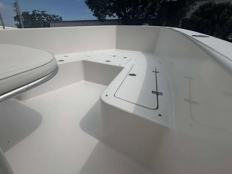 Slide: The Image of 2015 Andros Tarpon 26 boat deck with storage compartments and seating. - 6