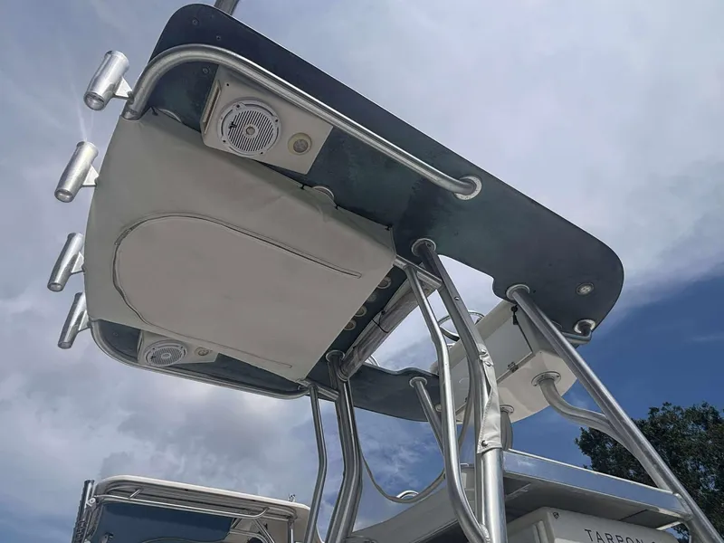 Slide: The Image of 2015 Andros Tarpon 26 boat tower with rod holders and speakers under a cloudy sky. - 10