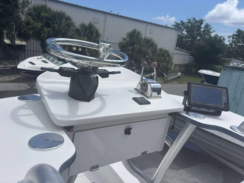 Slide: The Image of 2015 Andros Tarpon 26 boat helm with steering wheel and controls. - 11