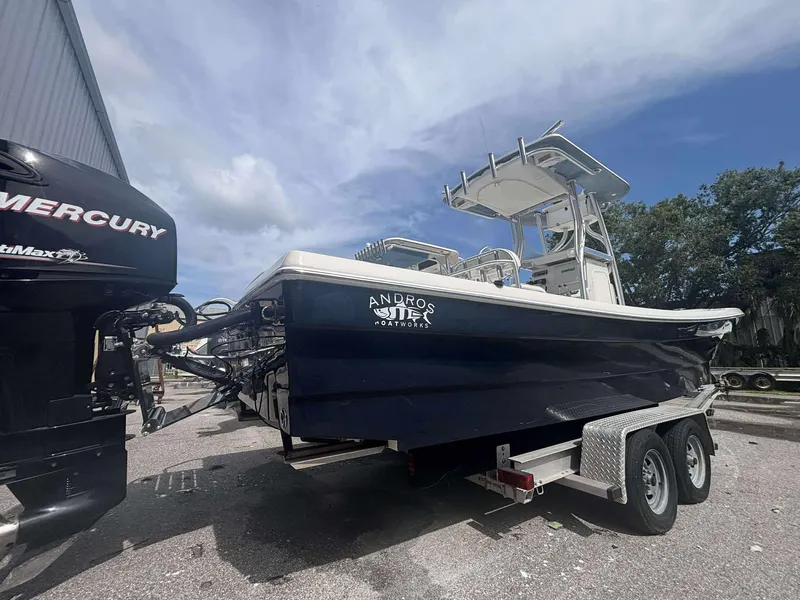 Slide: The Image of 2015 Andros Tarpon 26 boat on trailer with Mercury engine, parked outdoors. - 3