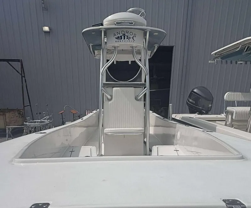 Slide: The Image of 2015 Andros Tarpon 26 boat with center console and Yamaha engine, docked indoors. - 5
