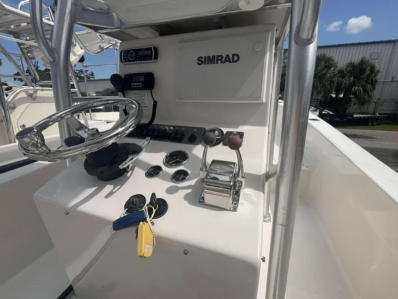 Slide: The Image of 2015 Andros Tarpon 26 boat console with steering wheel and Simrad electronics. - 8