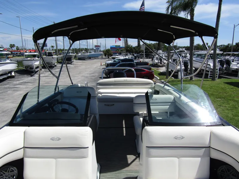 Slide: The Image of 2017 Cobalt Marker One Ml4 boat interior with seating and canopy, parked at a marina. - 18
