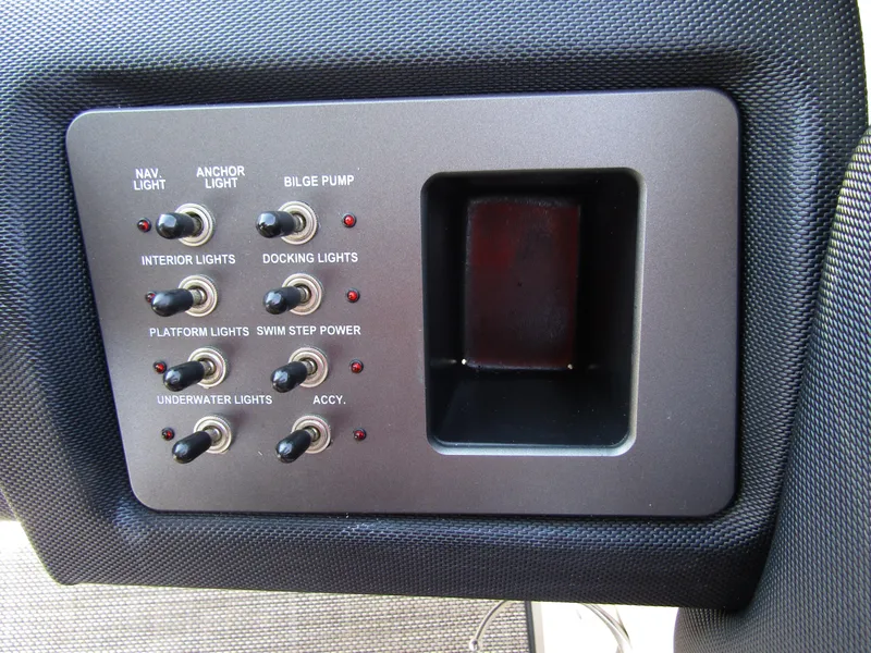 Slide: The Image of Control panel of a 2017 Cobalt Marker One Ml4 boat with various switches. - 24