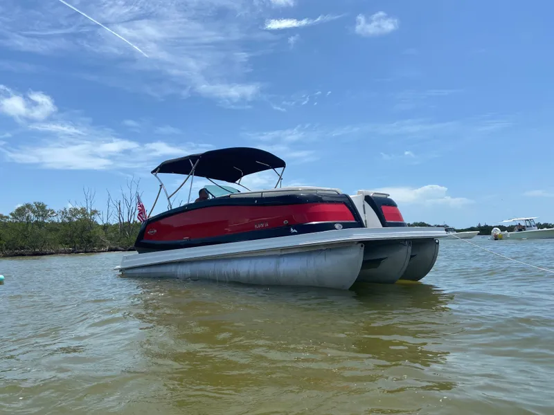 Slide: The Image of 2017 Cobalt Marker One Ml4 pontoon boat on calm water under blue sky. - 4