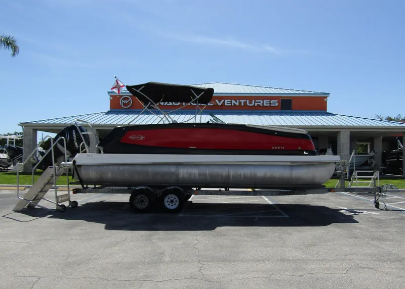 Slide: The Image of 2017 Cobalt Marker One Ml4 pontoon boat on trailer, parked outside dealership. - 9