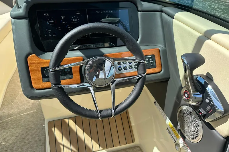 Slide: The Image of 2026 Chris-Craft Sportster 25 dashboard with steering wheel and control panel. - 12