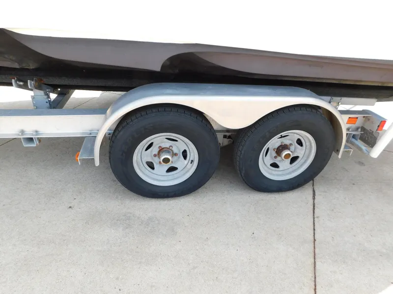 Slide: The Image of Trailer wheels of a 2017 Cutwater C-24 boat on concrete surface. - 13