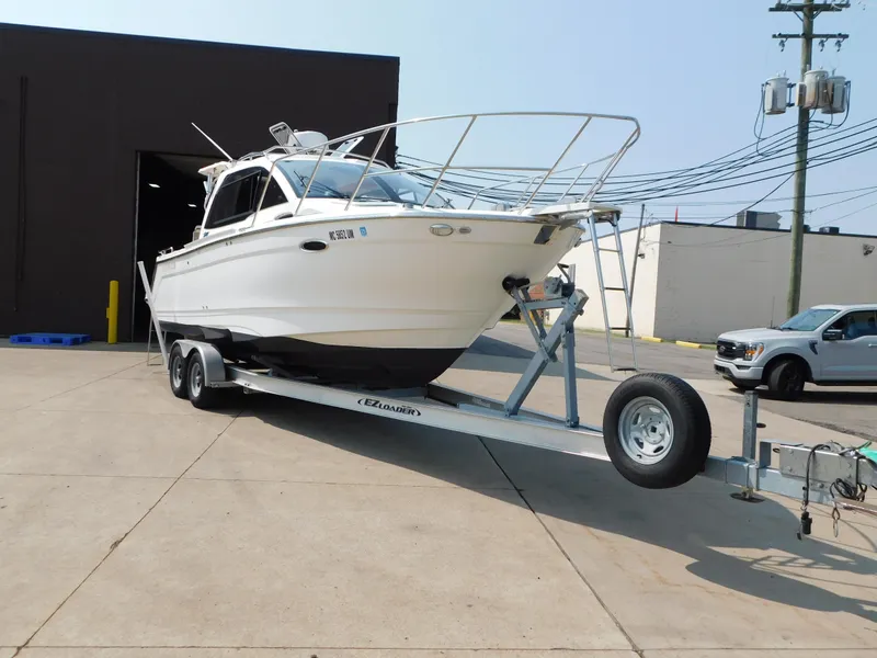 Slide: The Image of 2017 Cutwater C-24 boat on trailer in industrial area, ready for transport. - 2