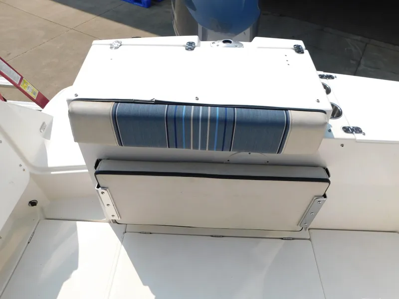 Slide: The Image of 2017 Cutwater C-24 boat seat with blue striped cushion, white deck background. - 20