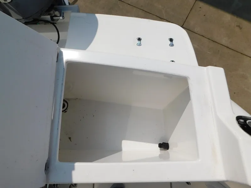 Slide: The Image of Open storage compartment on a 2017 Cutwater C-24 boat, showing interior space. - 28
