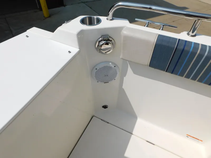 Slide: The Image of 2017 Cutwater C-24 boat interior with speaker, cup holder, and striped cushion. - 29