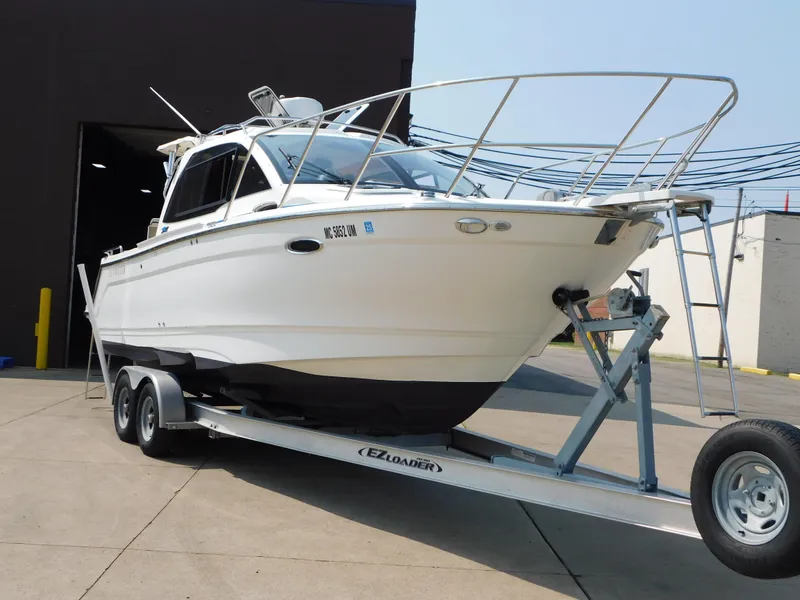 Slide: The Image of 2017 Cutwater C-24 boat on trailer outside a building. - 3