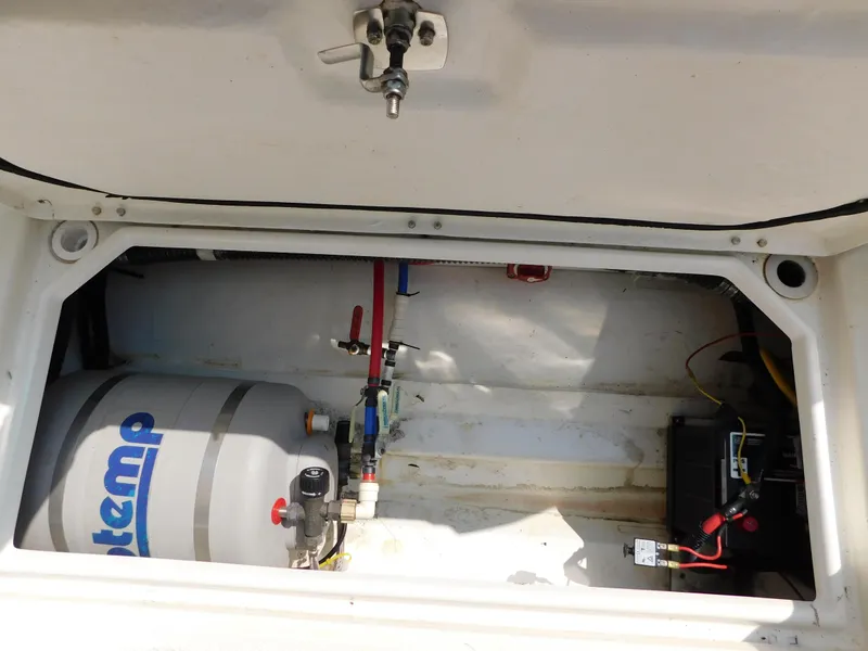 Slide: The Image of 2017 Cutwater C-24 boat compartment with water heater and battery setup. - 39