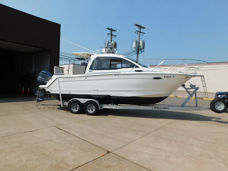 Slide: The Image of 2017 Cutwater C-24 boat on trailer, parked outdoors near a building. - 4