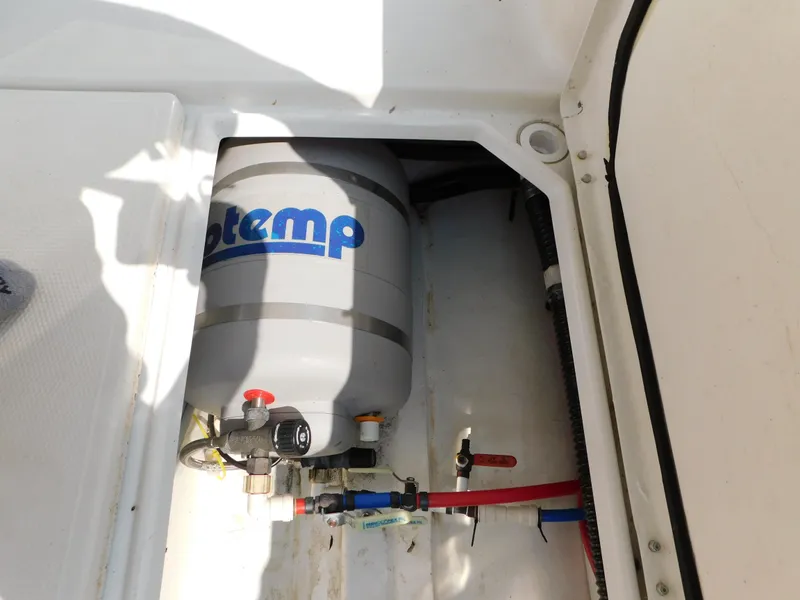 Slide: The Image of Boat water heater system in a 2017 Cutwater C-24, featuring a compact installation. - 40