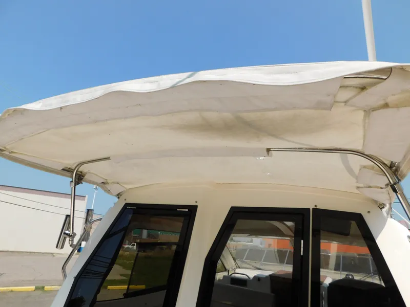 Slide: The Image of 2017 Cutwater C-24 boat canopy and windows under clear blue sky. - 47