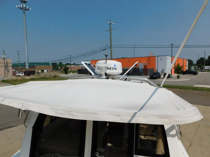 Slide: The Image of 2017 Cutwater C-24 boat with Garmin radar, docked near industrial buildings. - 49