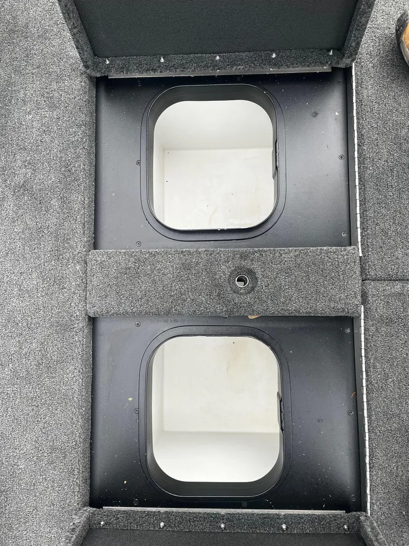 Slide: The Image of 2024 Skeeter ZXR 20 boat storage compartments with carpeted finish. - 10