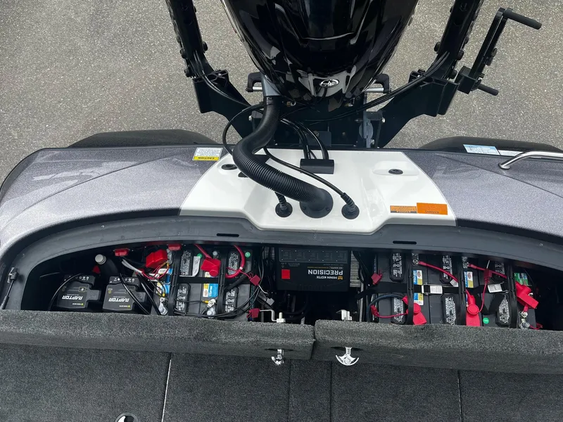 Slide: The Image of 2024 Skeeter ZXR 20 boat battery compartment with multiple batteries and wiring. - 13