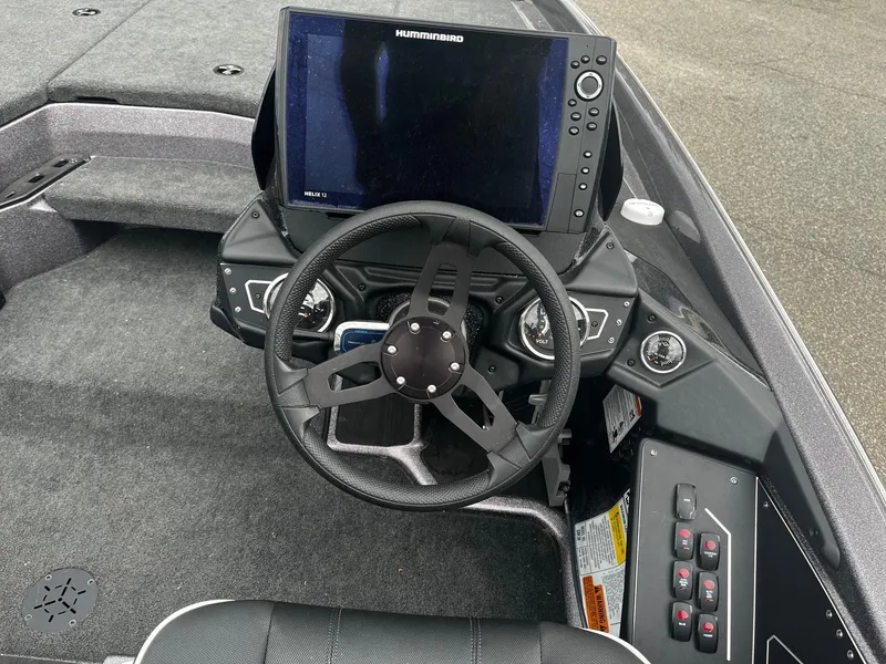 Slide: The Image of 2024 Skeeter ZXR 20 boat dashboard with steering wheel and Humminbird Helix 12 display. - 14