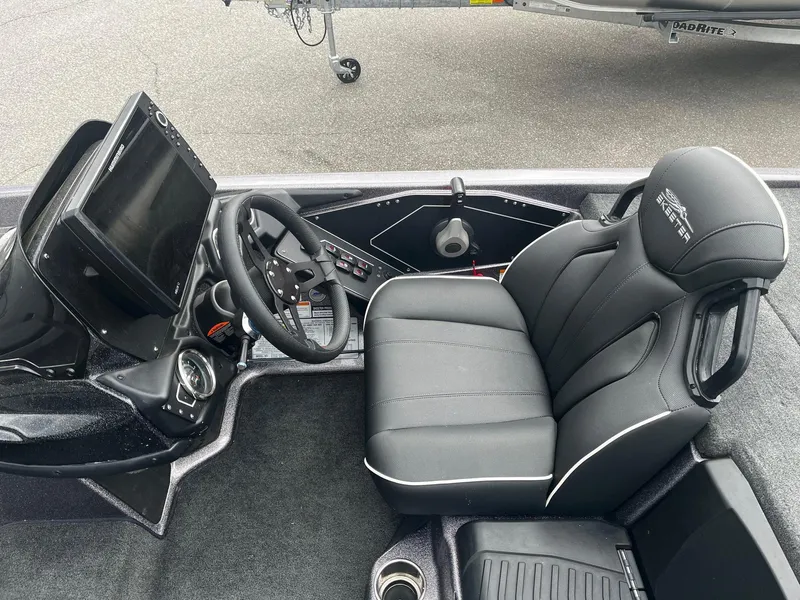 Slide: The Image of 2024 Skeeter ZXR 20 boat cockpit with steering wheel, seat, and control panel. - 16
