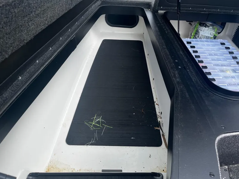 Slide: The Image of Storage compartment of 2024 Skeeter ZXR 20 boat with organized tackle boxes. - 22